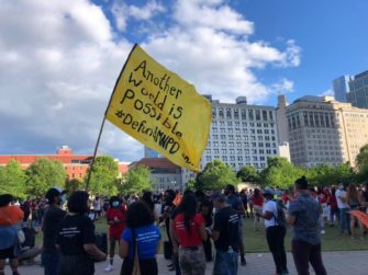 flag with the words "another world is possible #defundmnpd"